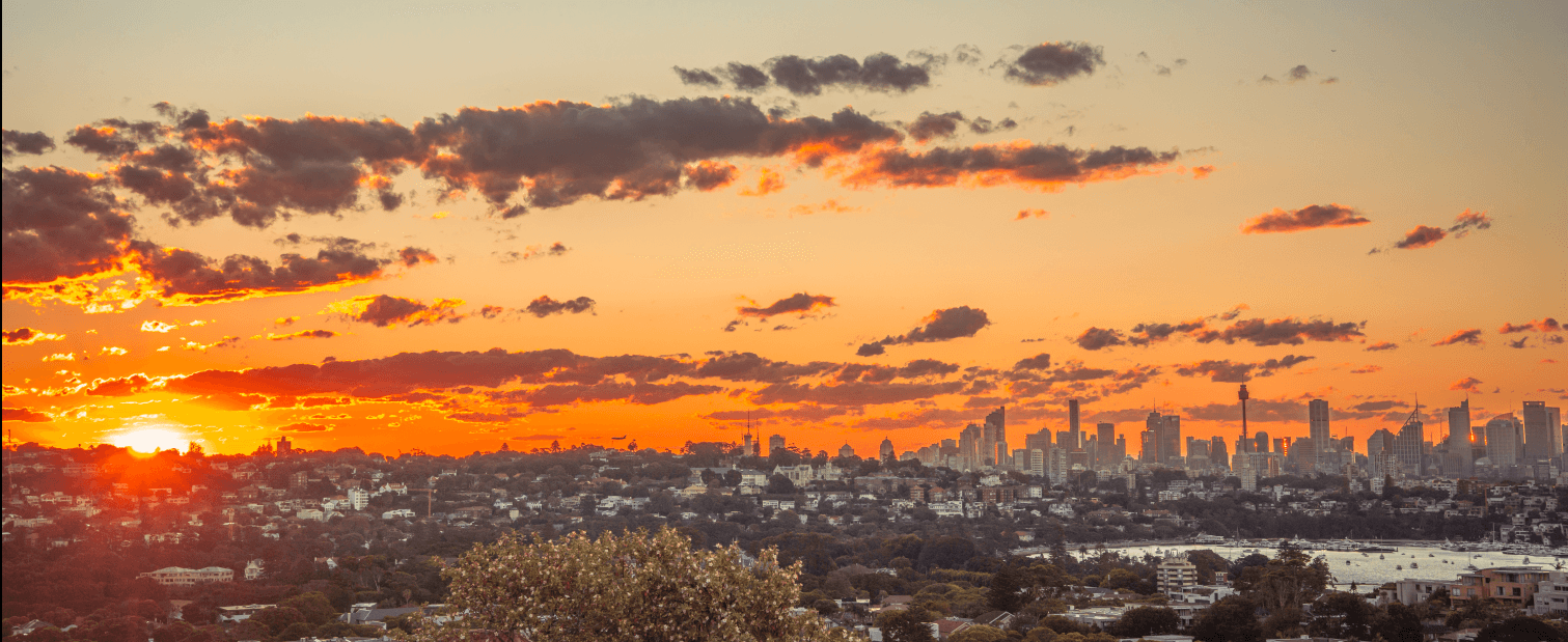Sydney cityscape at sunset with dramatic orange sky